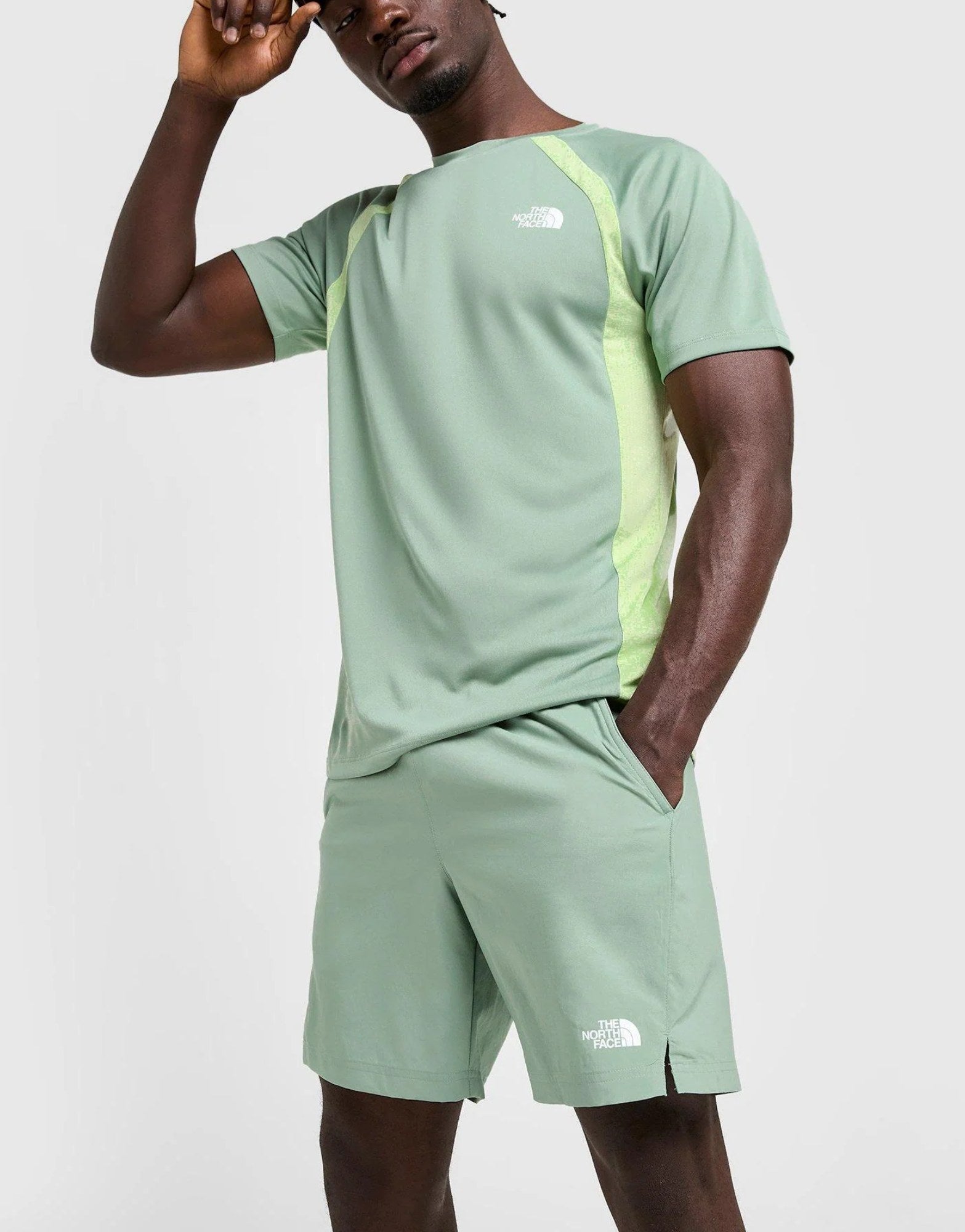 Person wearing a green athletic outfit with The North Face logo on a white background